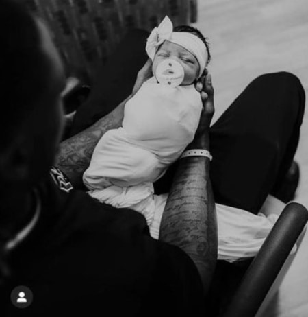 Adams with his newly born daughter